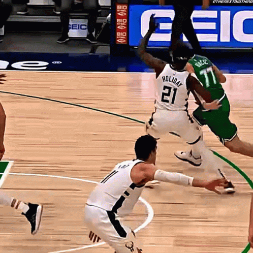 A Basketball Player Wearing A White Jersey With The Number 21 On It GIF