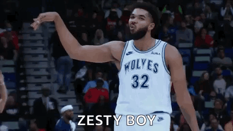 A Basketball Player Wearing A White Jersey With The Number 32 On It Is Standing On A Court . GIF