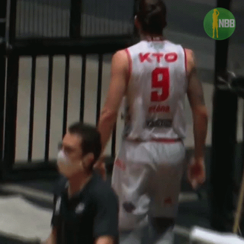 A Basketball Player Wearing A White Jersey With The Number 9 On The Back GIF