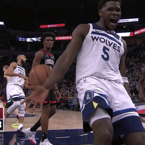 A Basketball Player Wearing A Wolves Jersey Is Holding A Basketball GIF