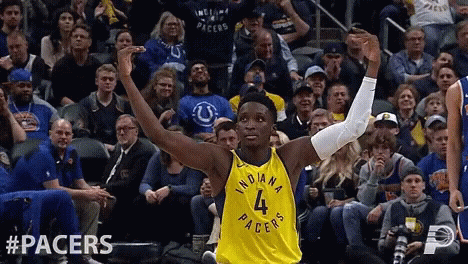 A Basketball Player Wearing A Yellow Indiana Pacers Jersey GIF