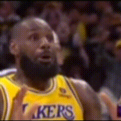 a basketball player wearing a yellow jersey that says lakers on it