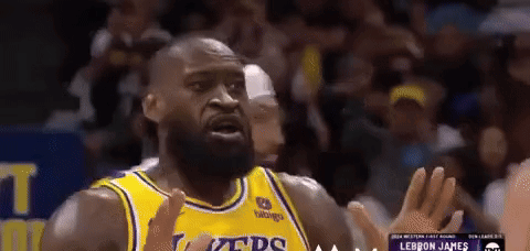 a basketball player wearing a yellow jersey that says lakers