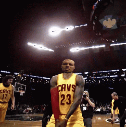 A Basketball Player Wearing A Yellow Jersey With The Number 23 GIF