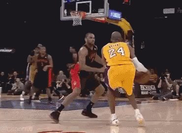 A Basketball Player Wearing A Yellow Jersey With The Number 24 On It Is Dribbling The Ball . GIF
