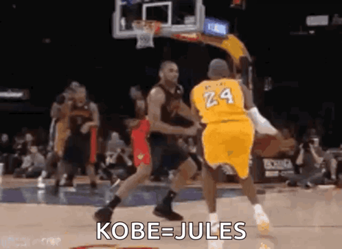 A Basketball Player Wearing A Yellow Jersey With The Number 24 On It Is Jumping In The Air While Playing Basketball . GIF