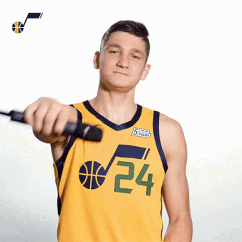 A Basketball Player Wearing A Yellow Jersey With The Number 24 On It GIF