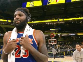 A Basketball Player Wearing Headphones And A Jersey With The Number 23 GIF