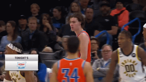 A Basketball Player Wearing Number 34 Stands In Front Of Another Player GIF