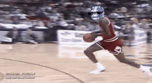 A Basketball Player Wearing Sunglasses And A Batman Mask Is Dribbling A Basketball . GIF