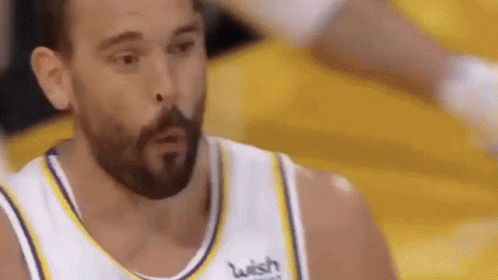 A Basketball Player With A Beard Is Making A Funny Face While Wearing A Wish Jersey . GIF