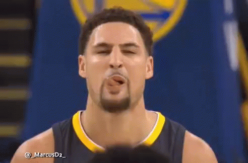 A Basketball Player With A Beard Is Smiling While Wearing A Jersey With A R On It . GIF