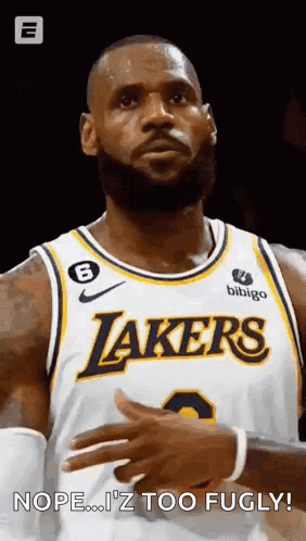 A Basketball Player With A Beard Is Wearing A Lakers Jersey And Looking At The Camera . GIF