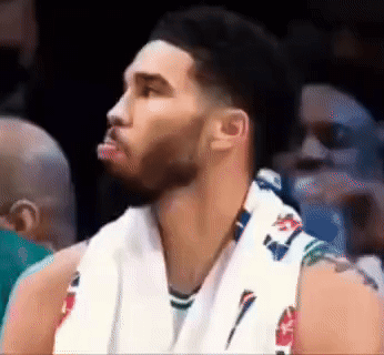 A Basketball Player With A Towel Around His Neck Looks To His Left GIF