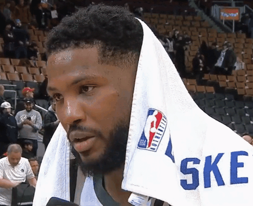 a basketball player with a towel wrapped around his head and the word ske on his shirt