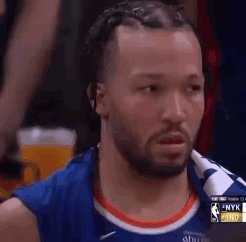 A Basketball Player With Dreadlocks And A Beard Is Looking At Something . GIF