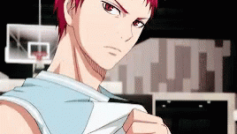 A Basketball Player With Red Hair Is Standing In Front Of A Basketball Hoop In A Gym . GIF