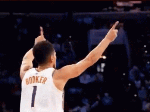 A Basketball Player With The Name Booker On His Shirt GIF