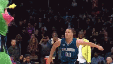 A Basketball Player With The Number 00 On His Jersey Is Jumping In The Air GIF