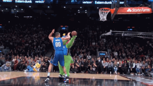 A Basketball Player With The Number 00 On His Jersey Tries To Dunk The Ball GIF