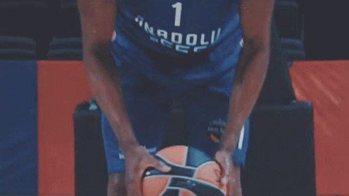 a basketball player with the number 1 on his jersey holds a basketball