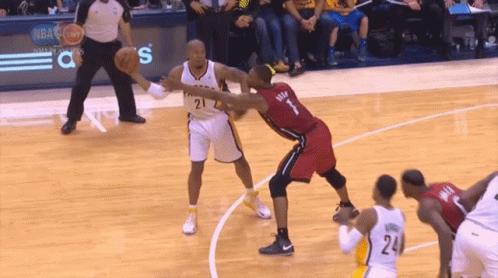 A Basketball Player With The Number 1 On His Jersey Is Defending Another Player GIF