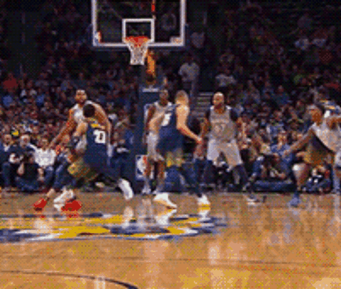 A Basketball Player With The Number 10 On His Back Is Dribbling The Ball GIF