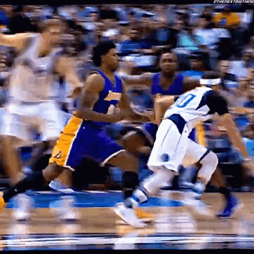 A Basketball Player With The Number 10 On His Jersey Is Being Chased By Another Player GIF