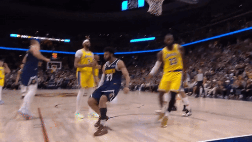 A Basketball Player With The Number 11 On His Jersey Is Dancing On The Court GIF