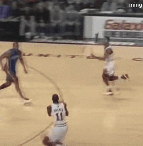 A Basketball Player With The Number 11 On His Jersey Is Dribbling The Ball GIF
