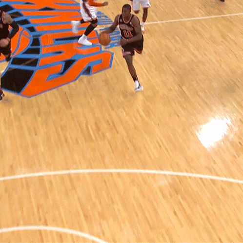 A Basketball Player With The Number 11 On His Jersey Is Dribbling The Ball GIF
