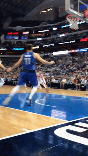 A Basketball Player With The Number 11 On The Back Of His Jersey Is Jumping In The Air GIF