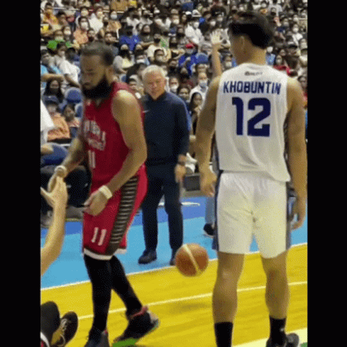 A Basketball Player With The Number 12 On His Back Is Talking To Another Player GIF