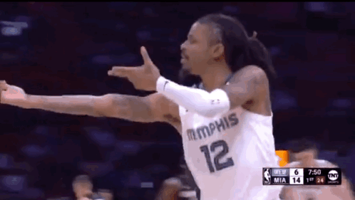 A Basketball Player With The Number 12 On His Jersey Is Celebrating GIF