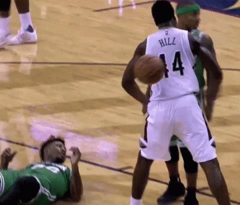 A Basketball Player With The Number 14 On His Jersey Is Holding A Basketball GIF