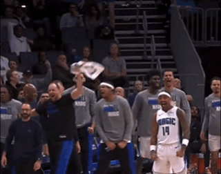 A Basketball Player With The Number 14 On His Jersey Stands In Front Of His Teammates GIF