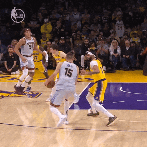 A Basketball Player With The Number 15 On His Jersey Dribbles The Ball GIF