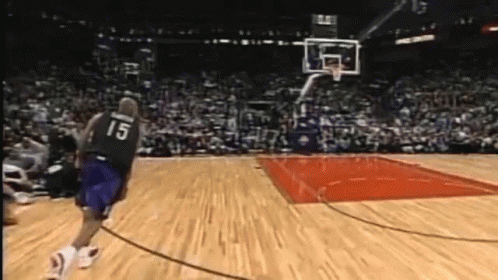 A Basketball Player With The Number 15 On His Jersey Runs Towards The Basket GIF