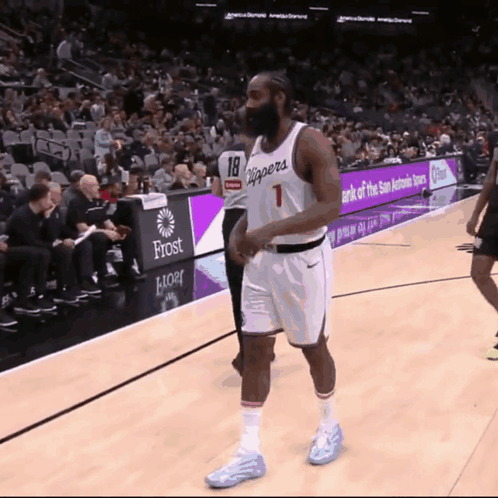 A Basketball Player With The Number 18 On His Jersey Walks On The Court GIF