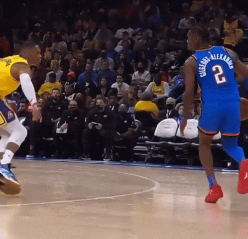 A Basketball Player With The Number 2 On His Back Dribbles The Ball GIF