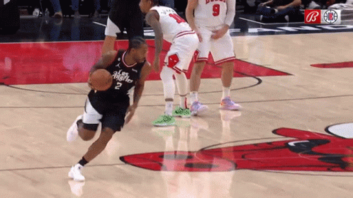 A Basketball Player With The Number 2 On His Jersey Is Dribbling A Basketball GIF