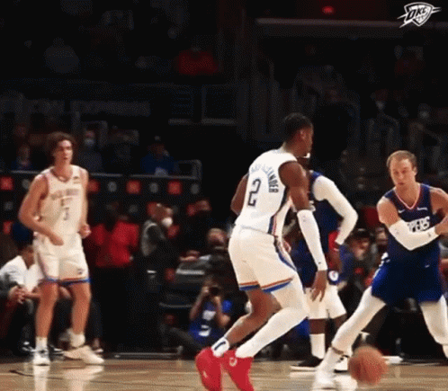 A Basketball Player With The Number 2 On His Shorts Is Dribbling The Ball During A Game . GIF