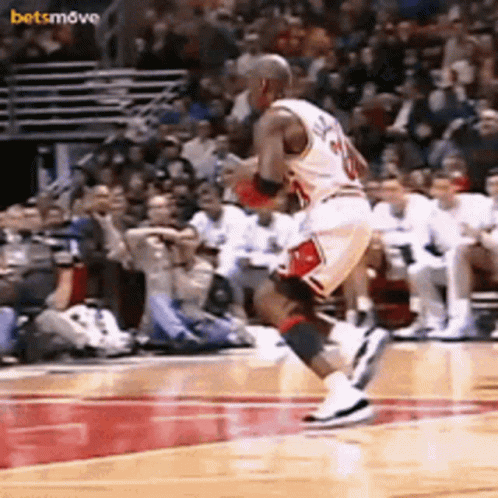 A Basketball Player With The Number 20 On His Jersey Is Jumping In The Air GIF