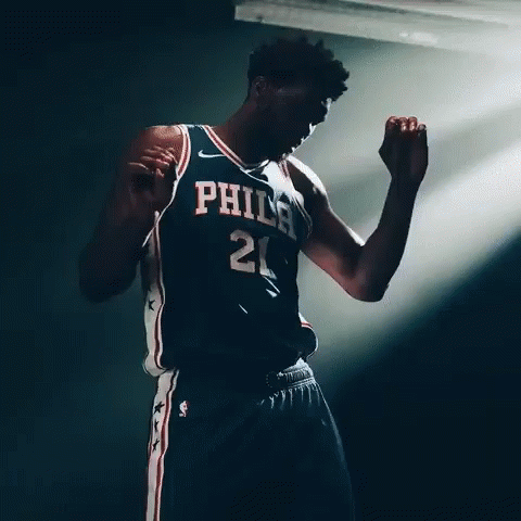 A Basketball Player With The Number 21 On His Jersey Is Dancing GIF