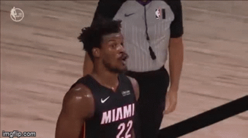 A Basketball Player With The Number 22 On His Jersey Is Standing On The Court . GIF