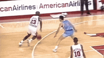 A Basketball Player With The Number 23 On His Jersey Dribbles The Ball GIF