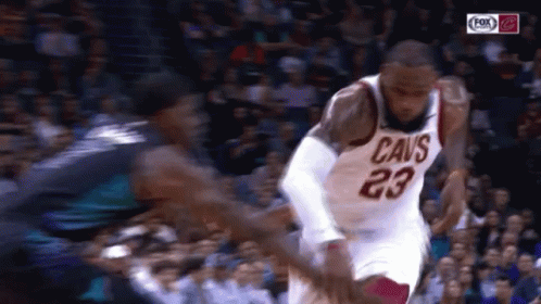 A Basketball Player With The Number 23 On His Jersey Is Dribbling A Ball GIF