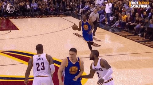 A Basketball Player With The Number 23 On His Jersey Is Dribbling The Ball GIF