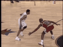 A Basketball Player With The Number 23 On His Jersey Is Dribbling The Ball GIF