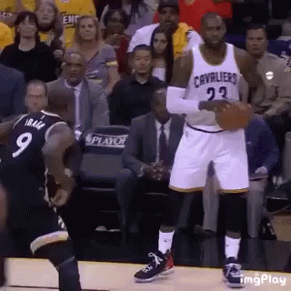 A Basketball Player With The Number 23 On His Jersey Is Holding A Basketball . GIF